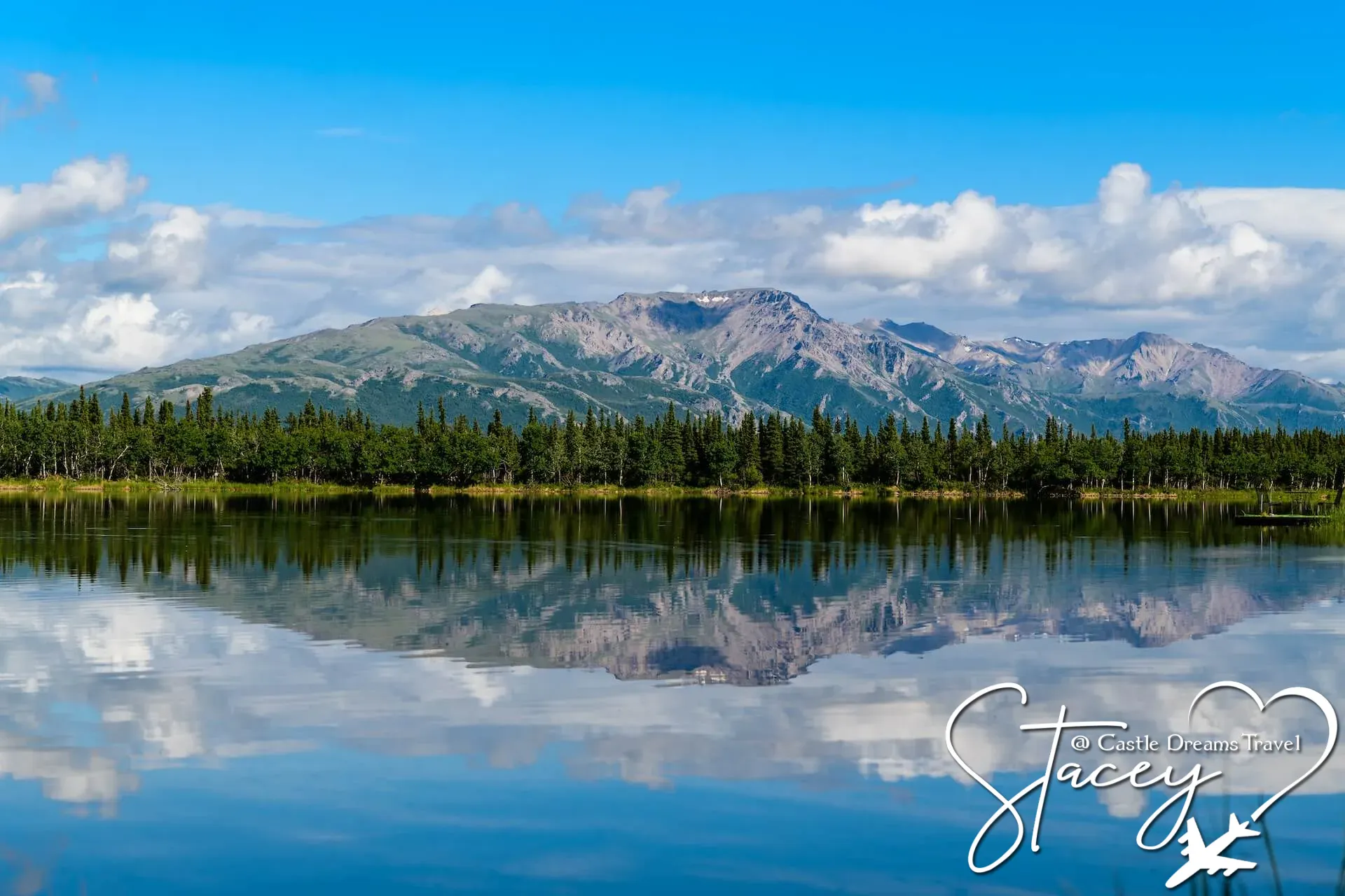 Alaskan mountain range and evergreen forest reflected in a still lake