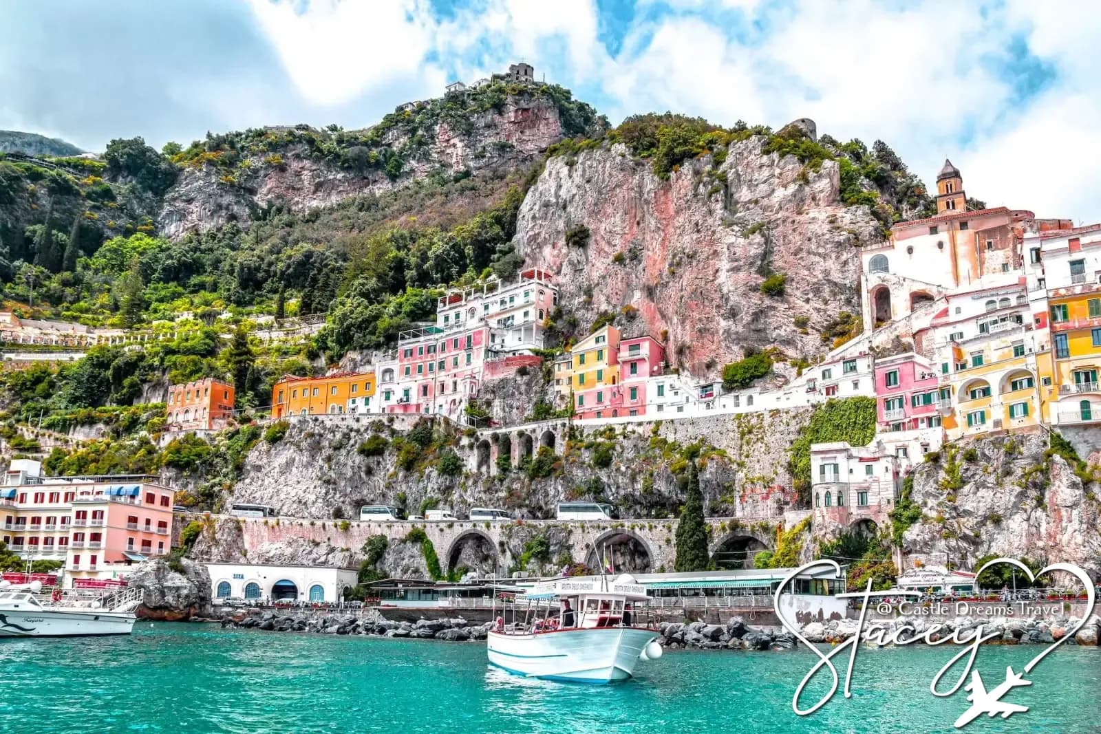 Pastel houses cascading down cliffs on the Amalfi Coast