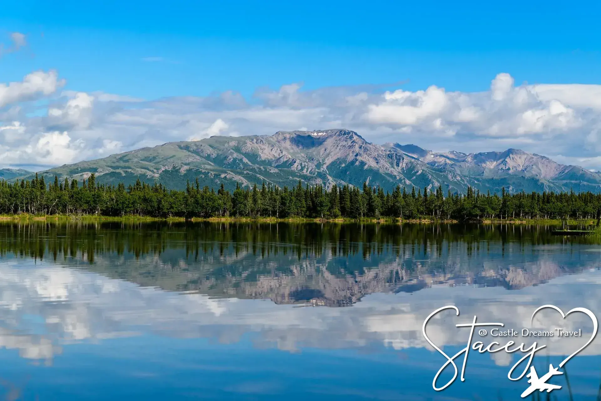 Alaskan mountain range and evergreen forest reflected in a still lake