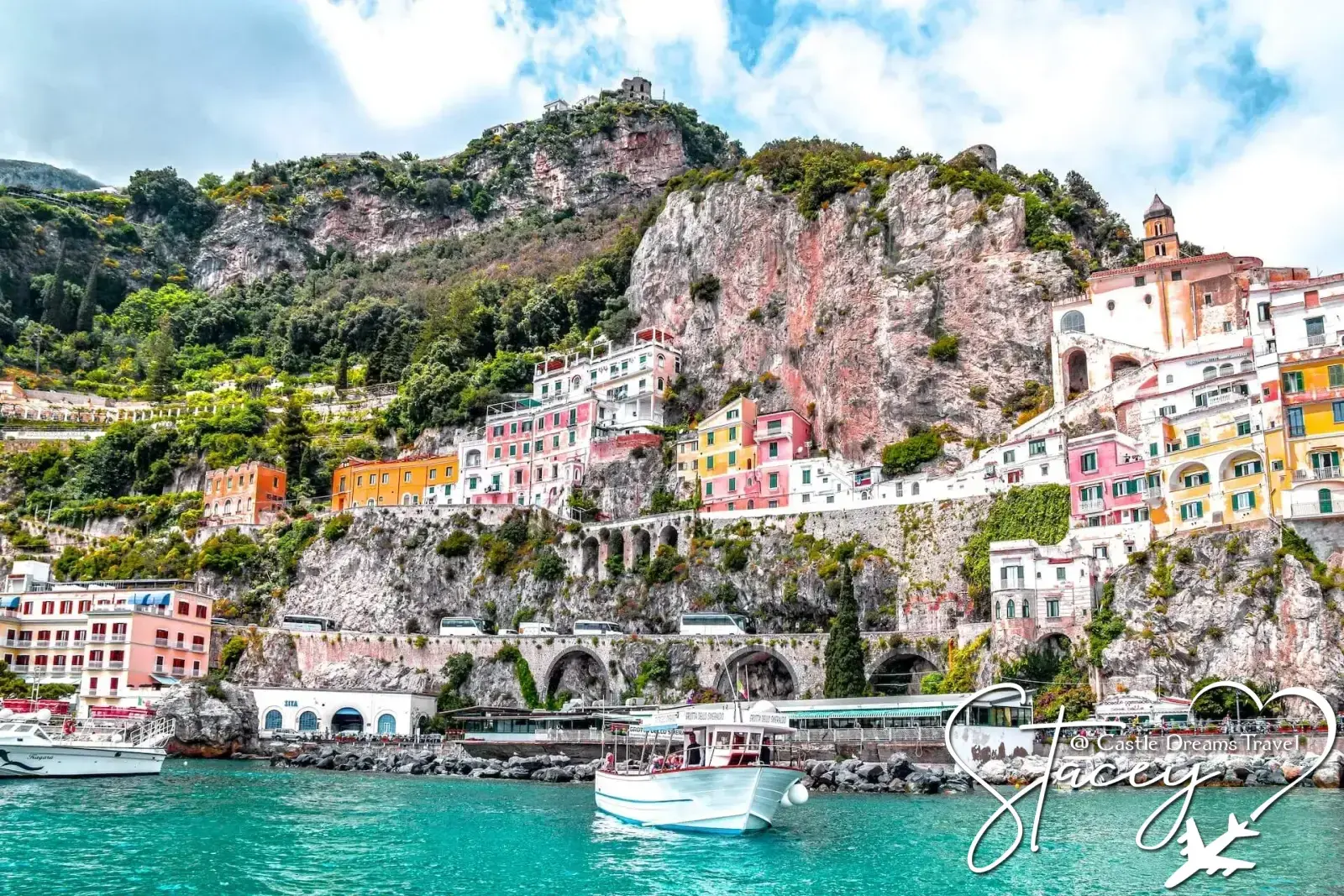 Pastel houses cascading down cliffs on the Amalfi Coast