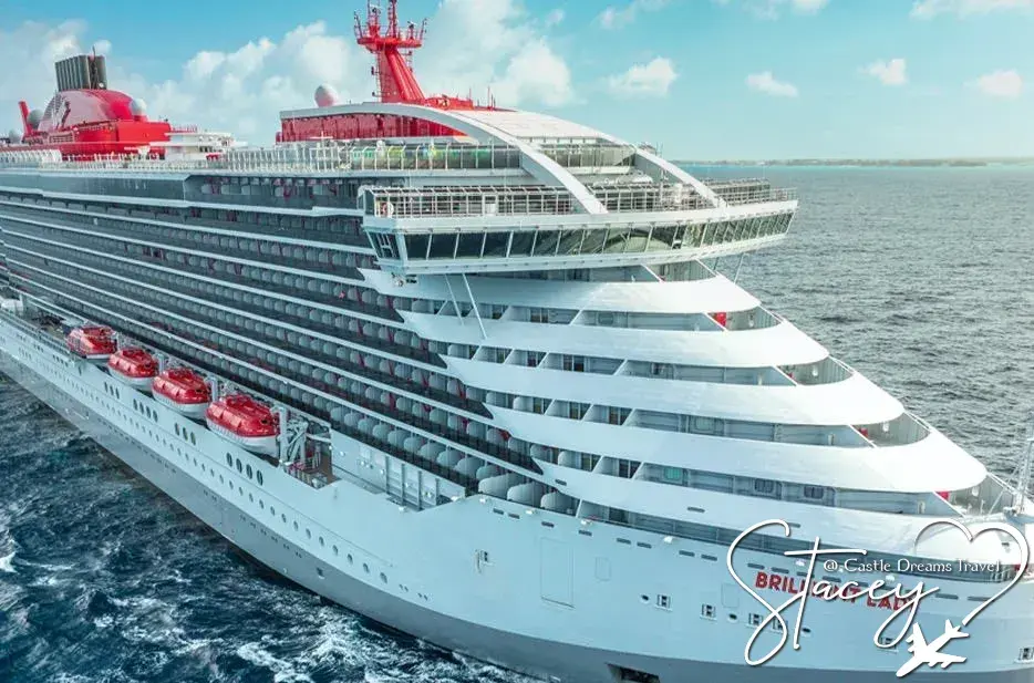 Virgin Voyages' Brilliant Lady at sea, name visible on the bow