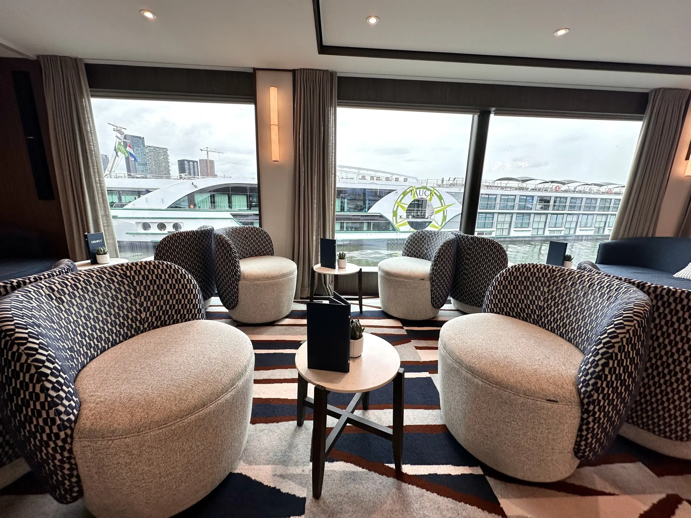 Rounded armchairs and river views in the lounge of a Viva Cruises ship