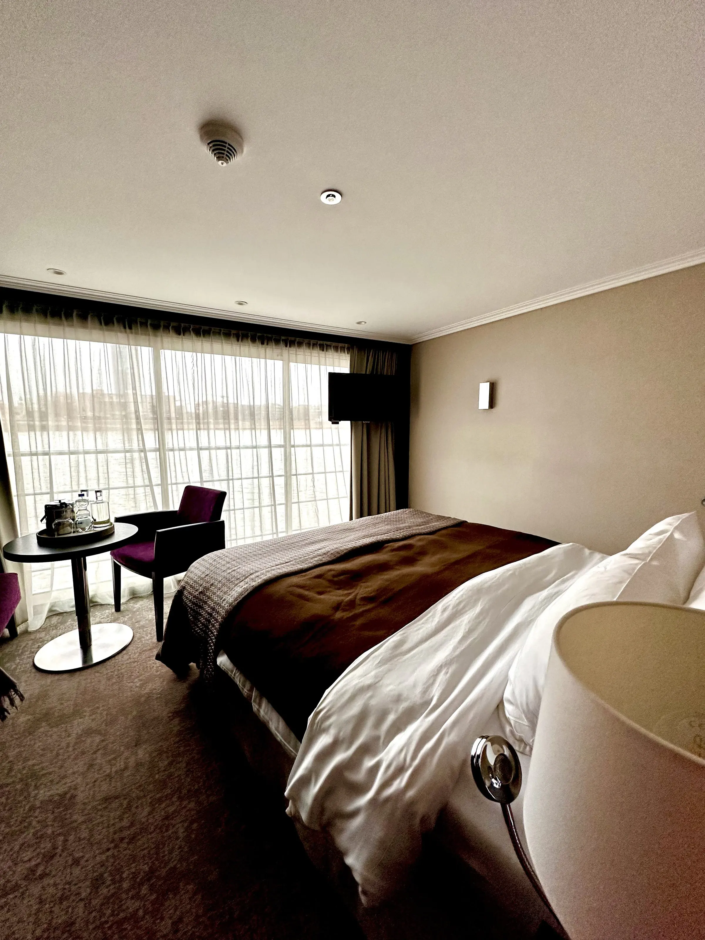An Avalon Panorama Suite with the bed facing the full-width window
