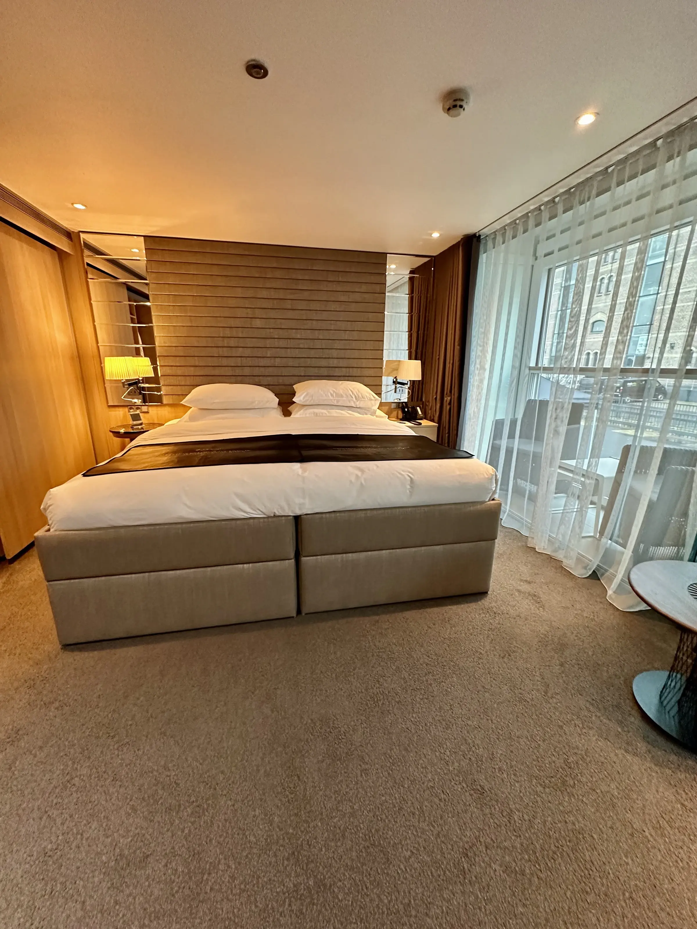 A Scenic suite with twin beds facing a full-width balcony window