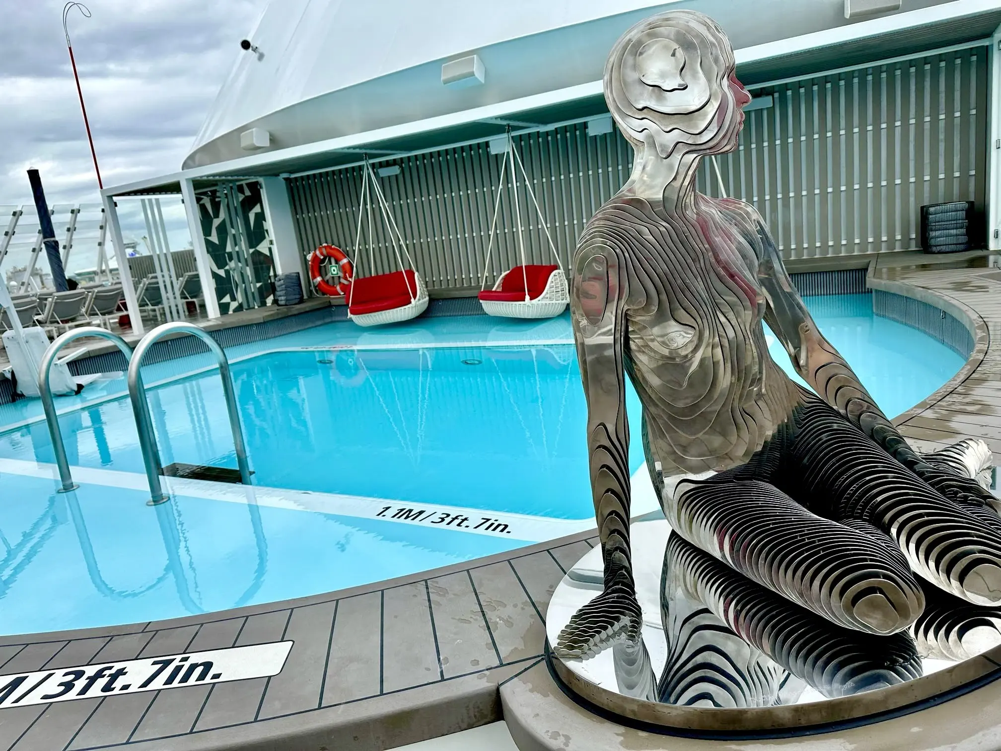 A sculpture beside the pool on the Rooftop Garden deck of a Celebrity ship