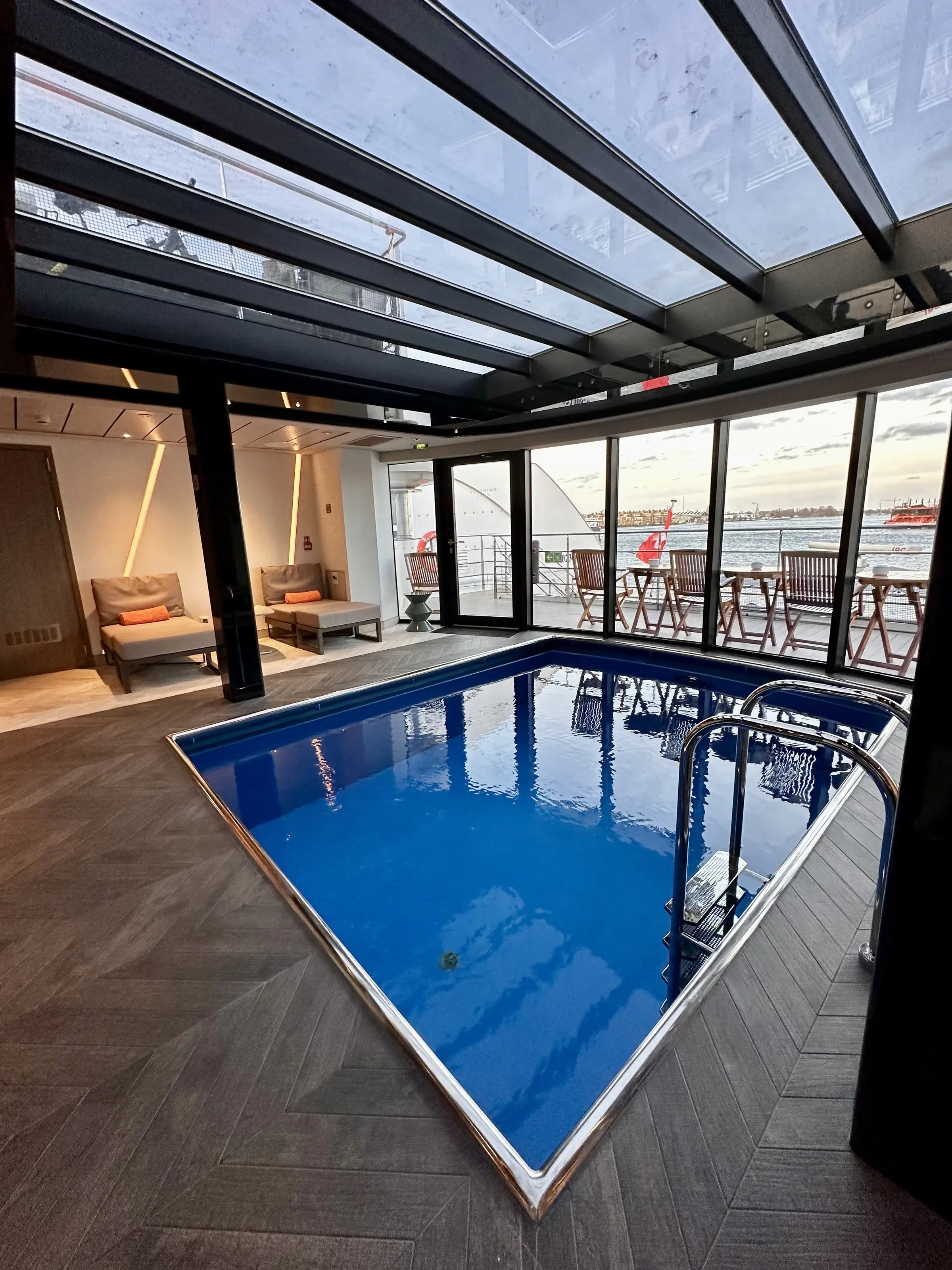 An indoor swimming pool under a glass roof aboard a Riverside river ship