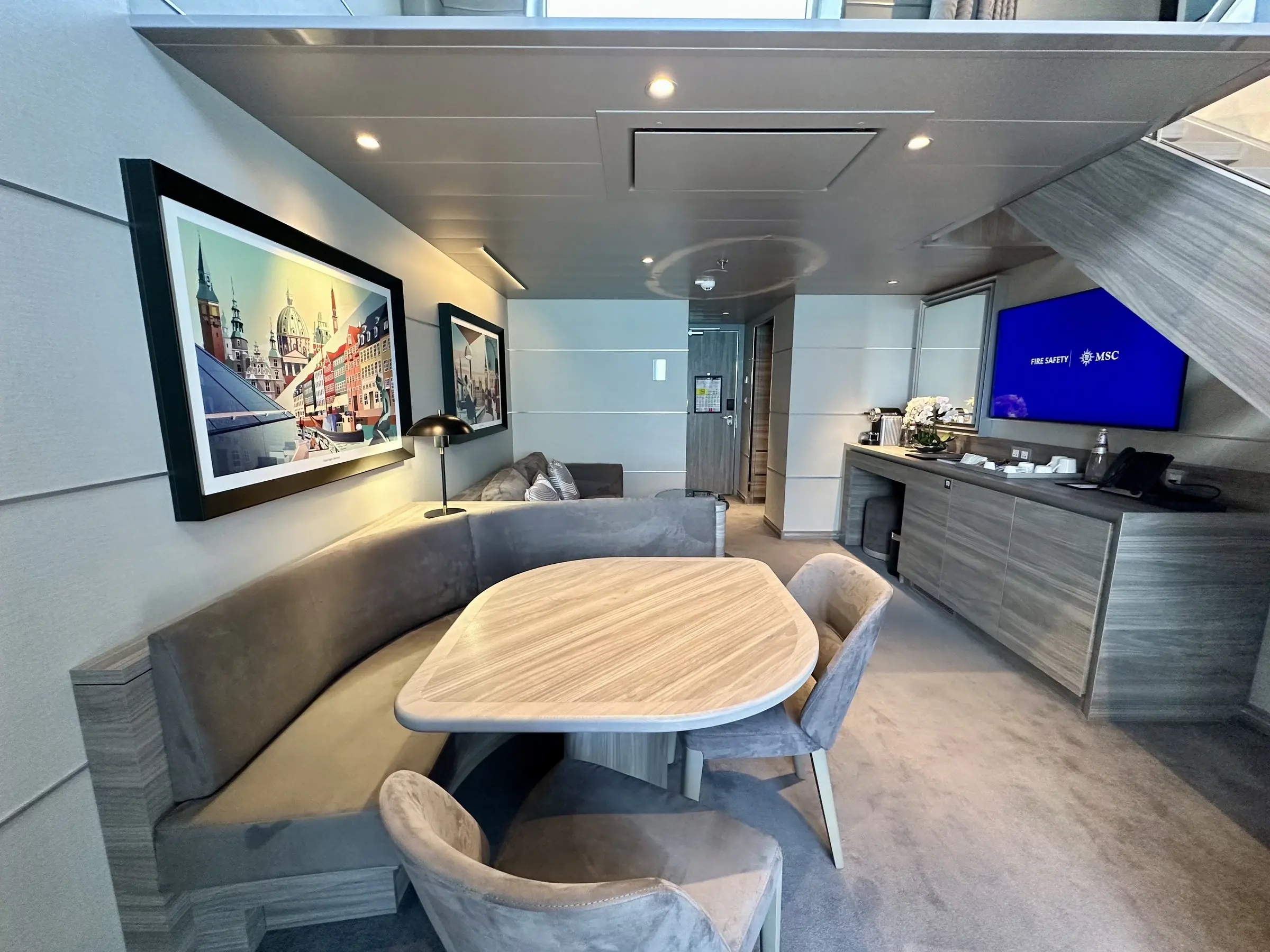 The dining and living area of an MSC Yacht Club suite