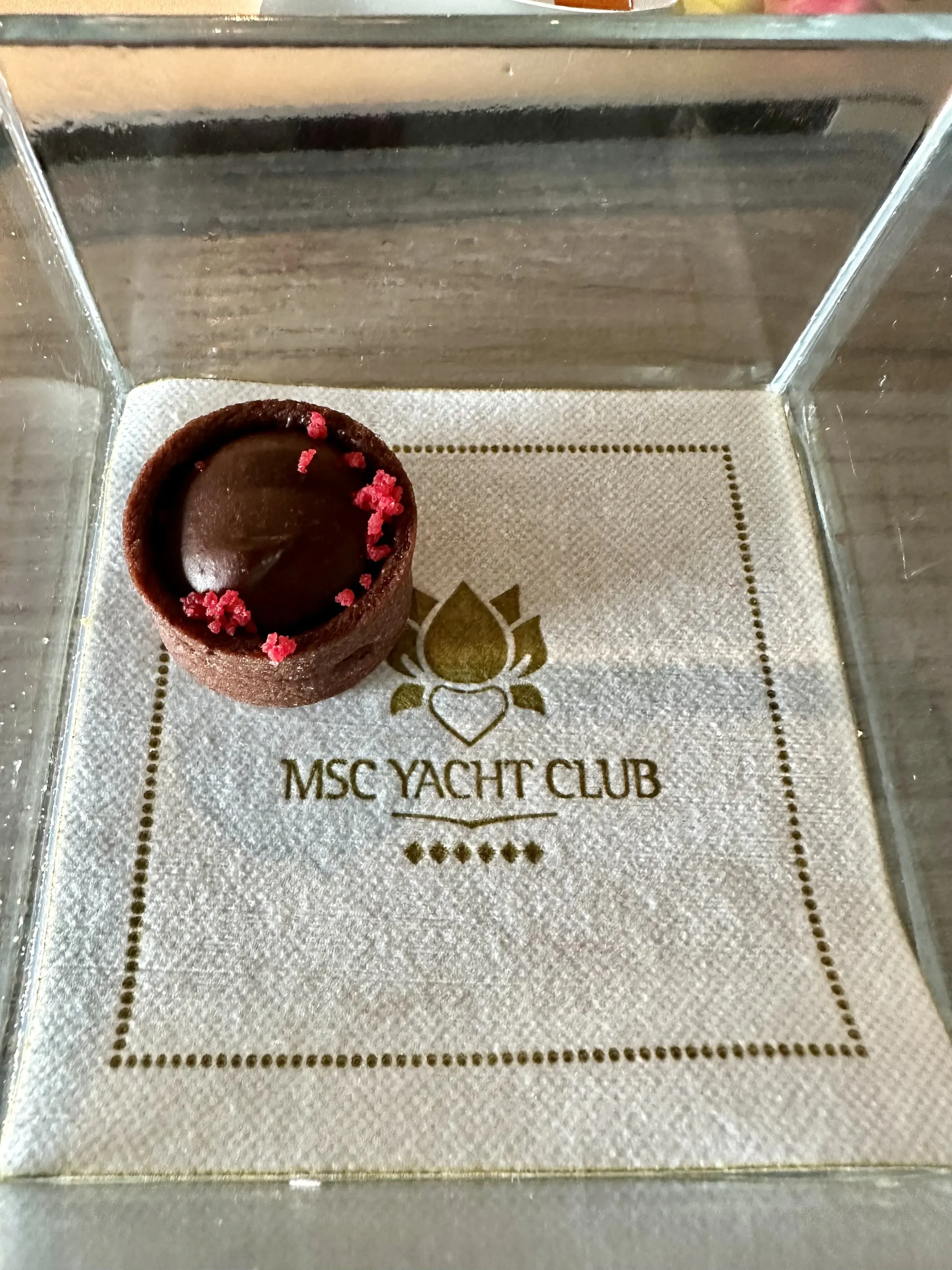 A chocolate dessert served on an MSC Yacht Club napkin