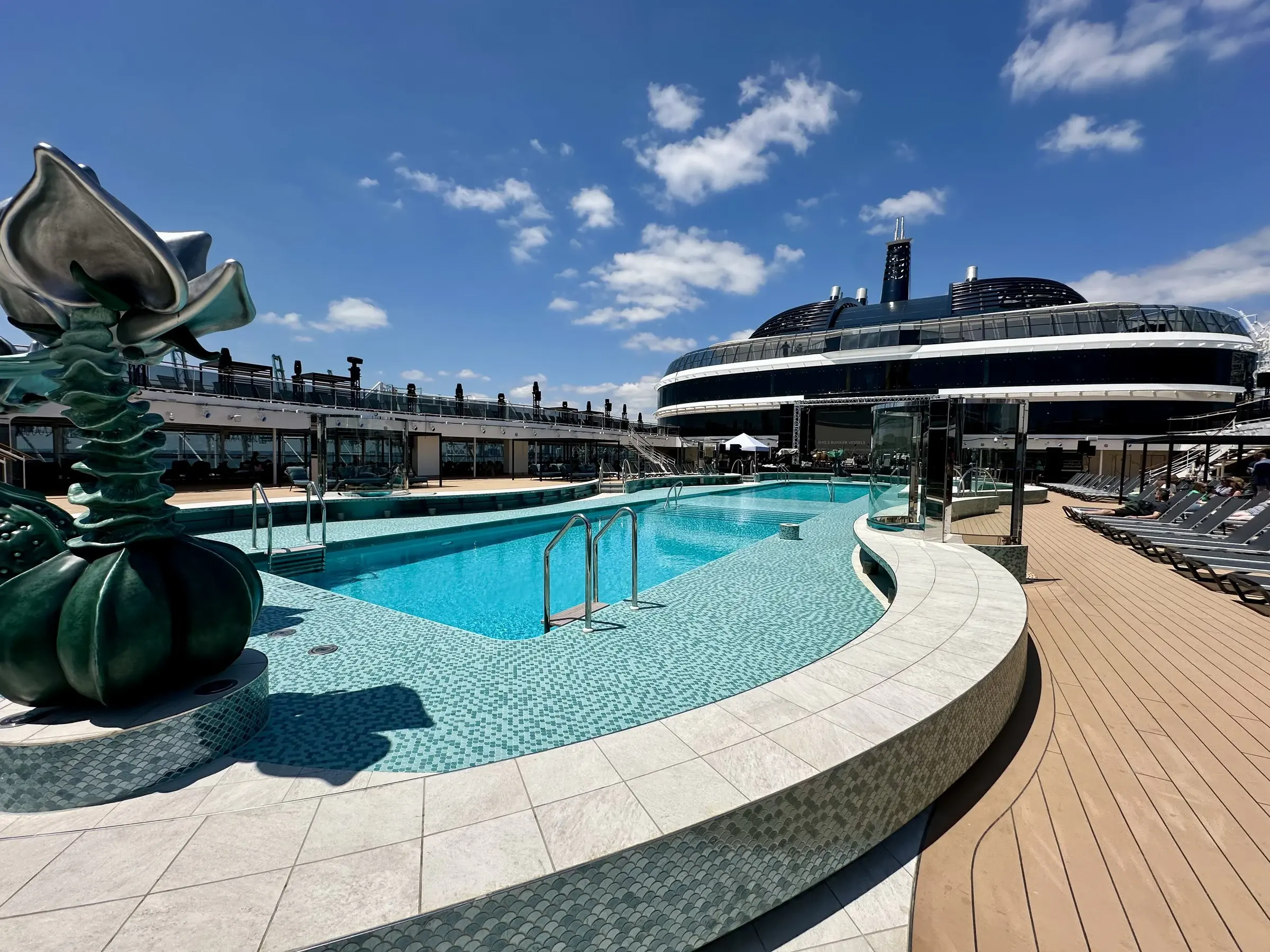 The main MSC pool deck with its tall green sculptures under a blue sky