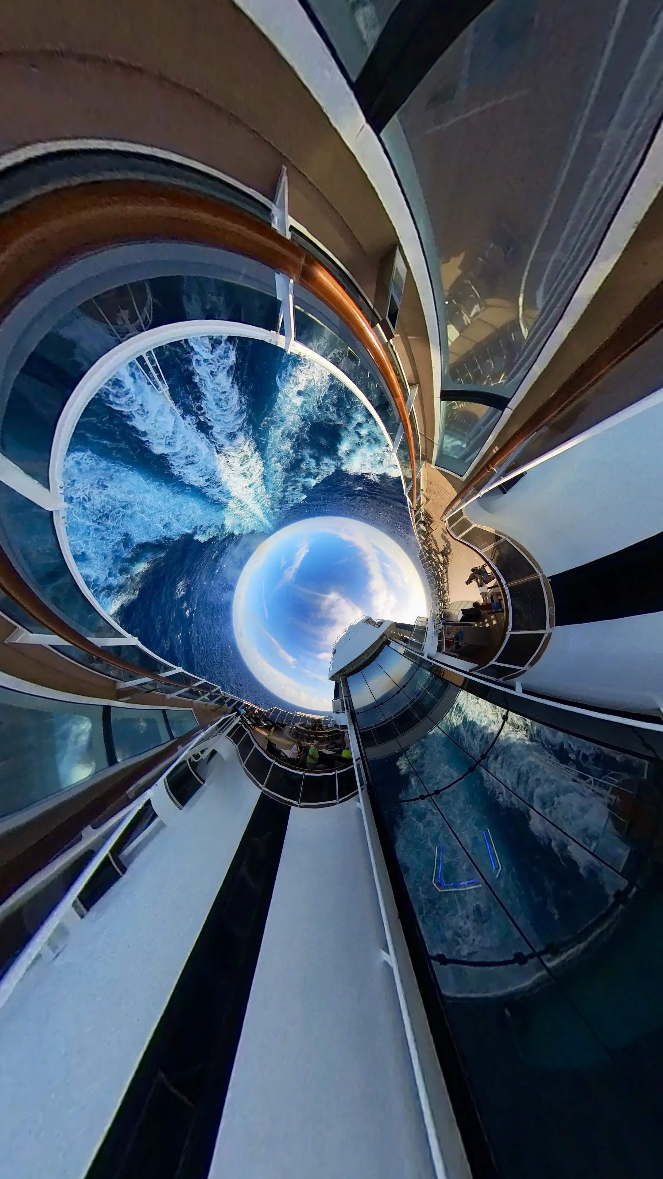 A swing ride suspended high over the ocean on the side of an MSC ship