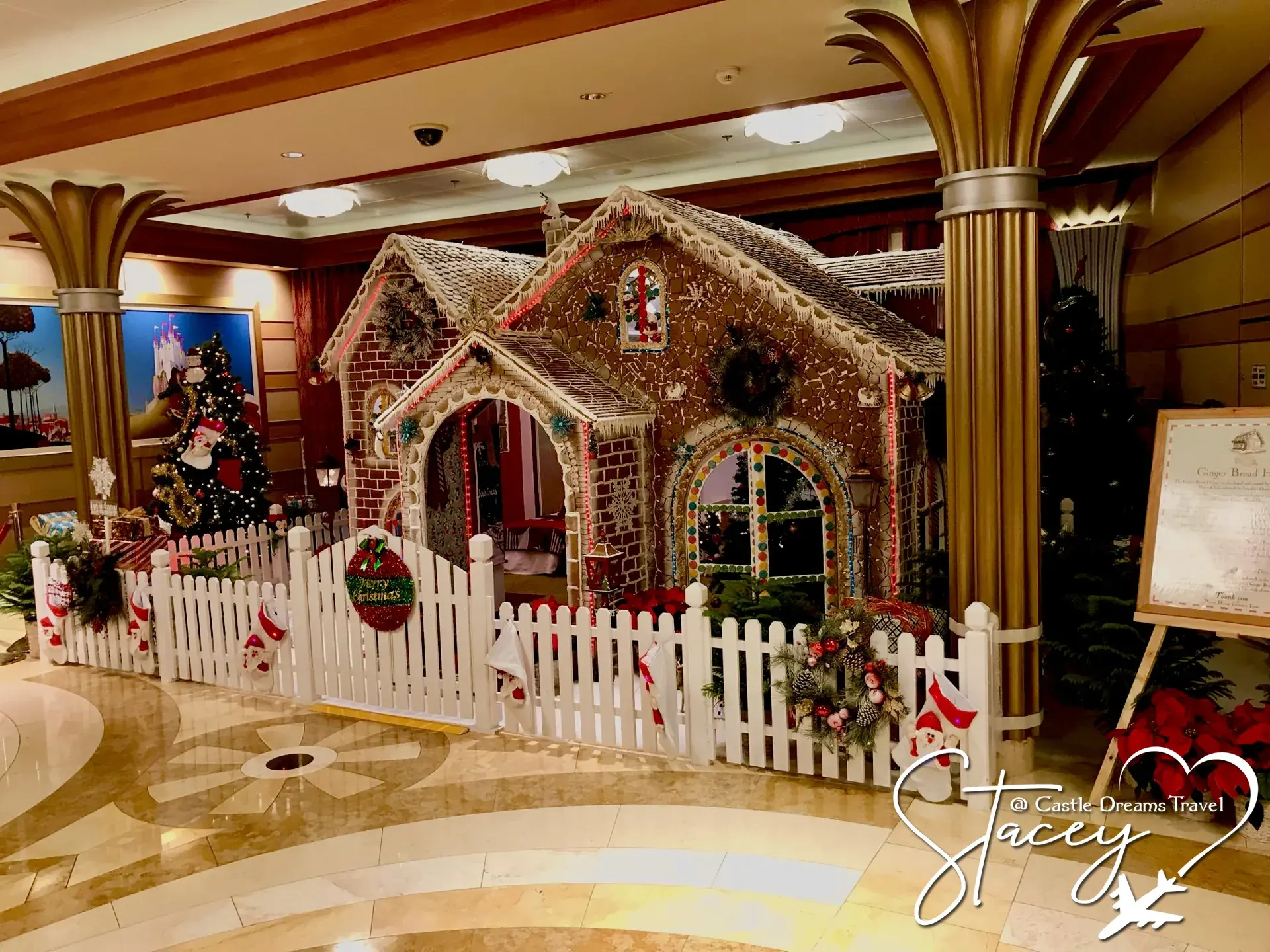 Life-size gingerbread house on display in the Disney Dream atrium at Christmas