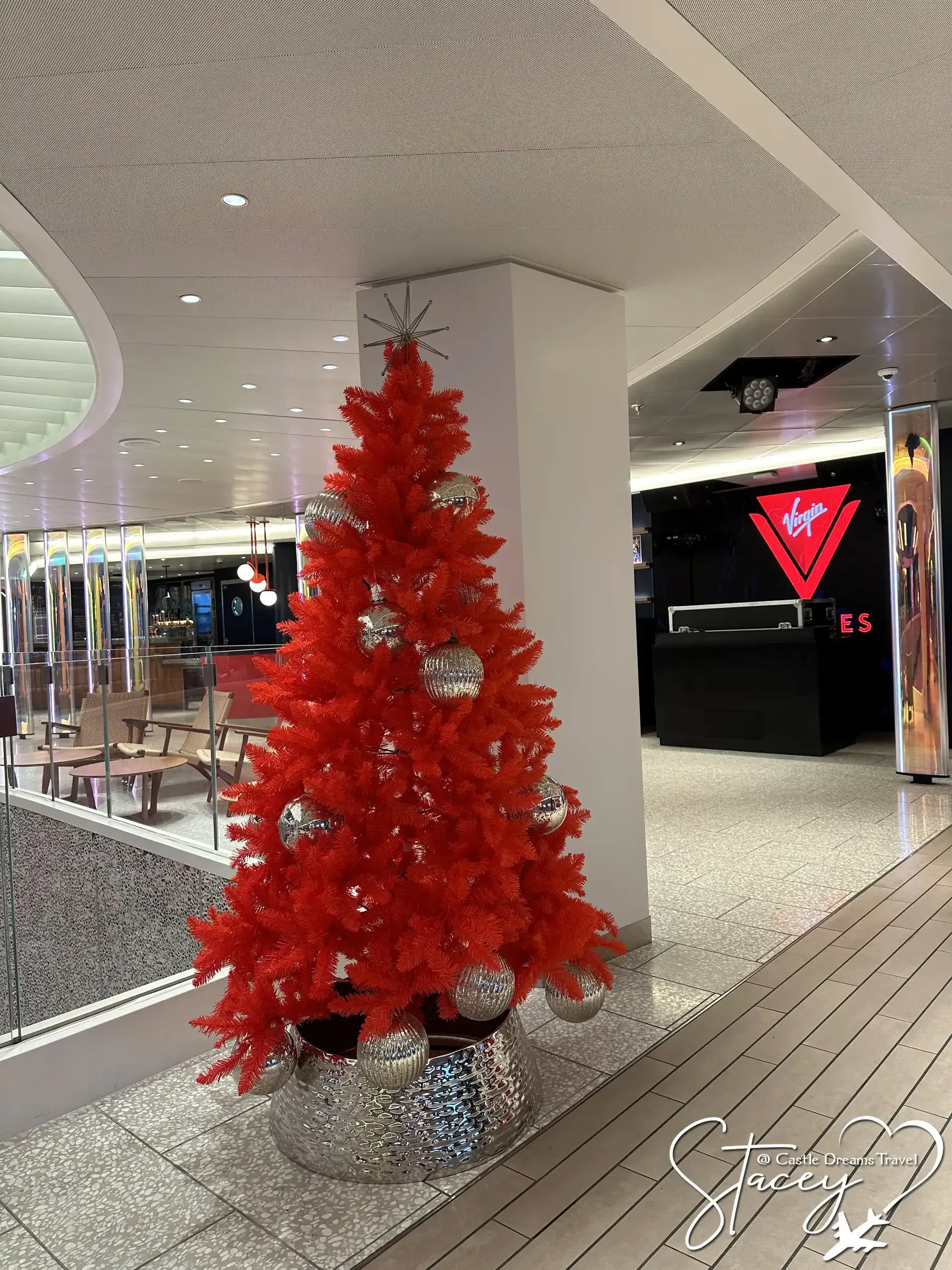 Bright red Christmas tree aboard a Virgin Voyages ship