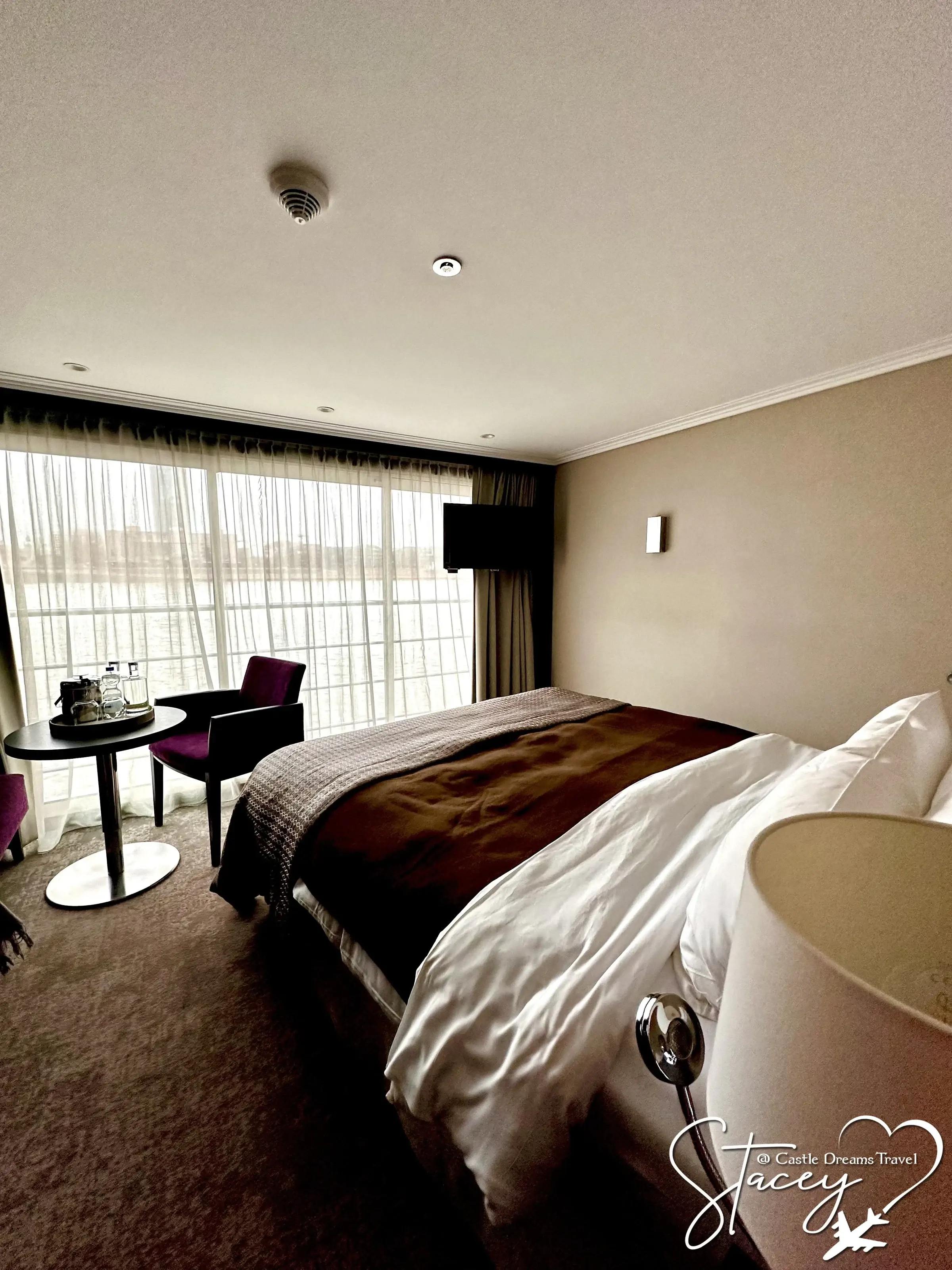 An Avalon Panorama Suite with the bed facing the full-width window