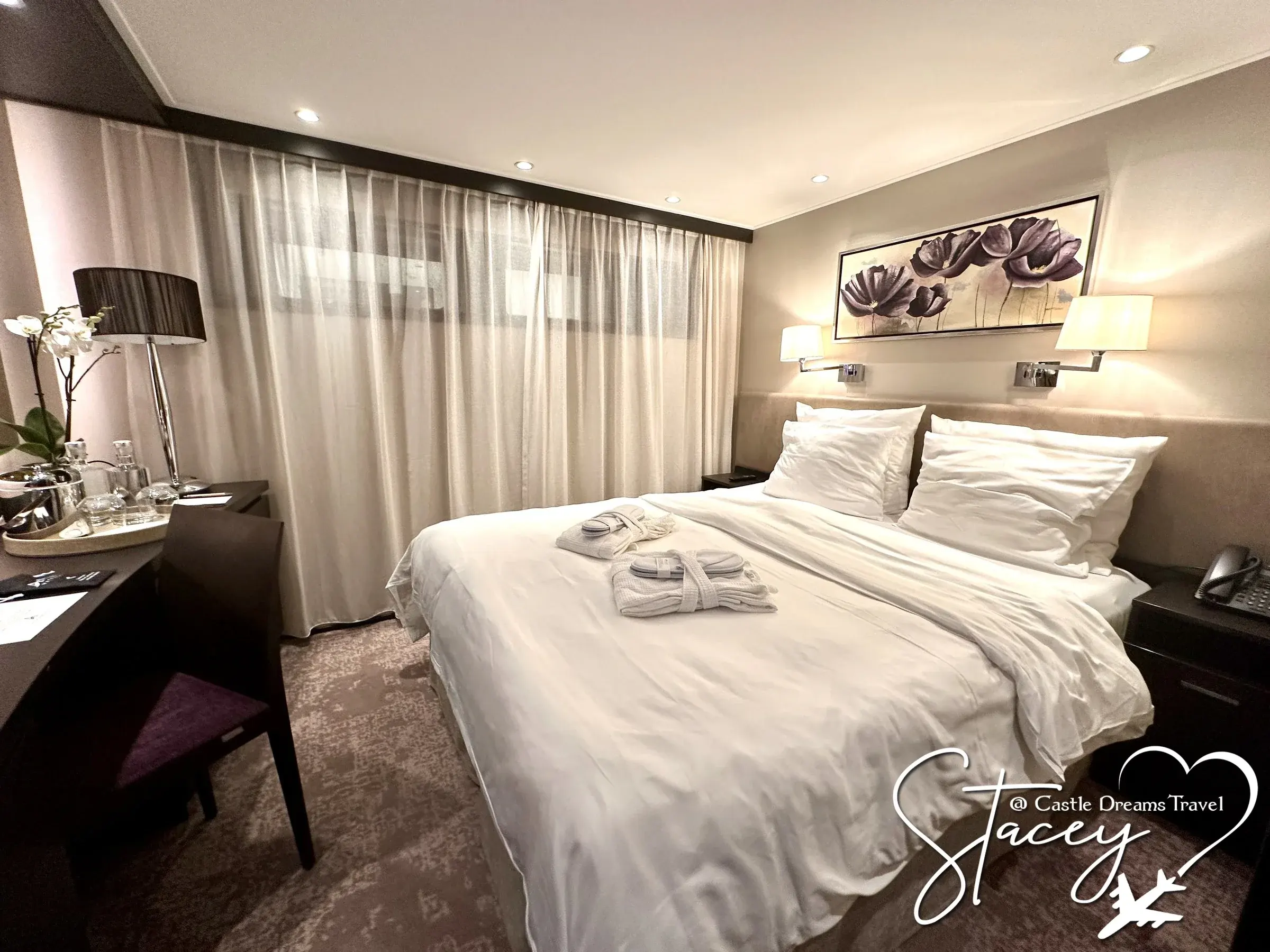 An Amadeus river ship stateroom with a wide bed and reading lamps