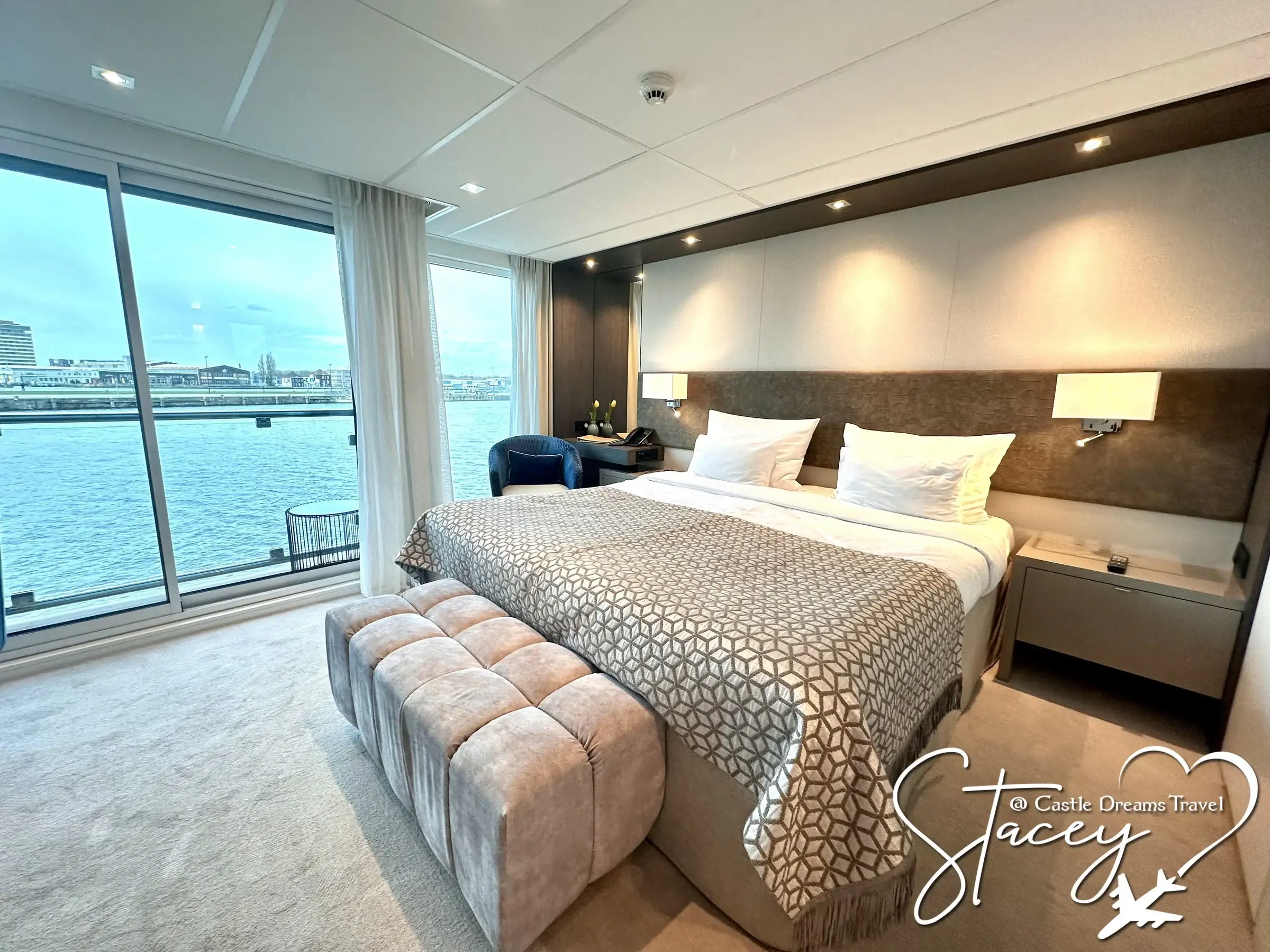 An Amadeus stateroom opening onto a full-width window above the water