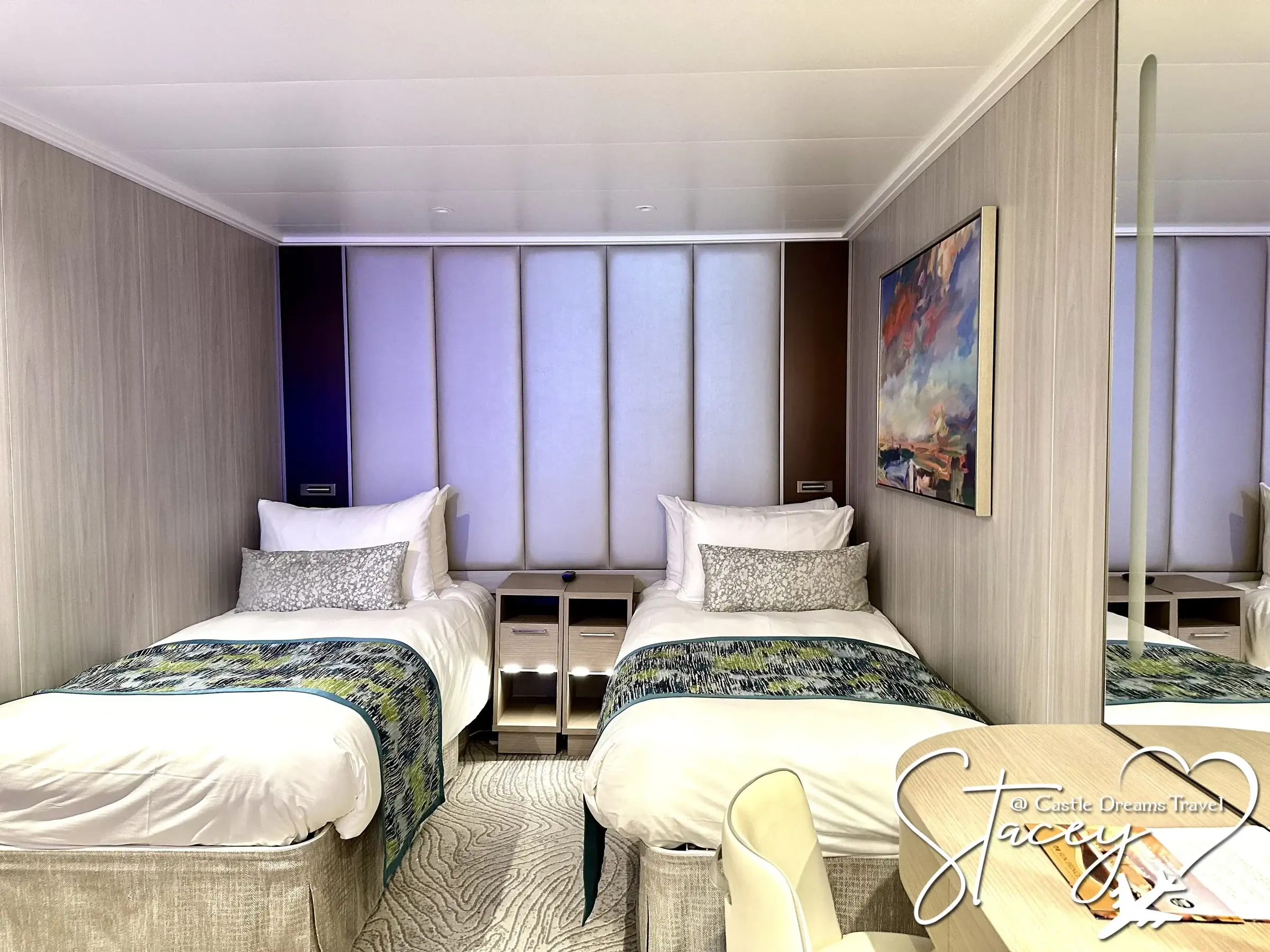 A Princess Cruises stateroom with twin beds and patterned throws