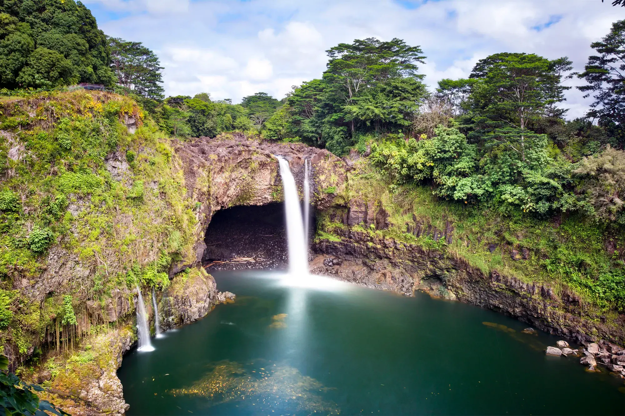 Rainbow Falls plunging into a lush green pool in Hilo on Hawaii's Big Island